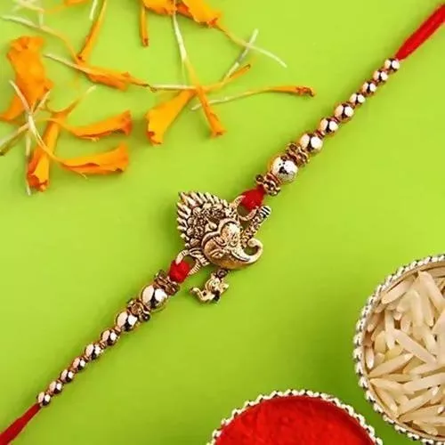Auspicious Ganesha Rakhi And Kaju Rolls Box - Combo